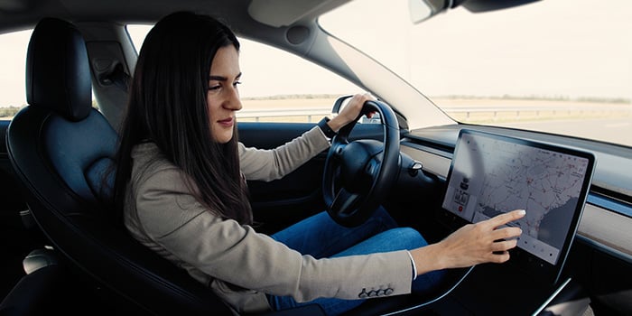 Woman interacting with her EVs console